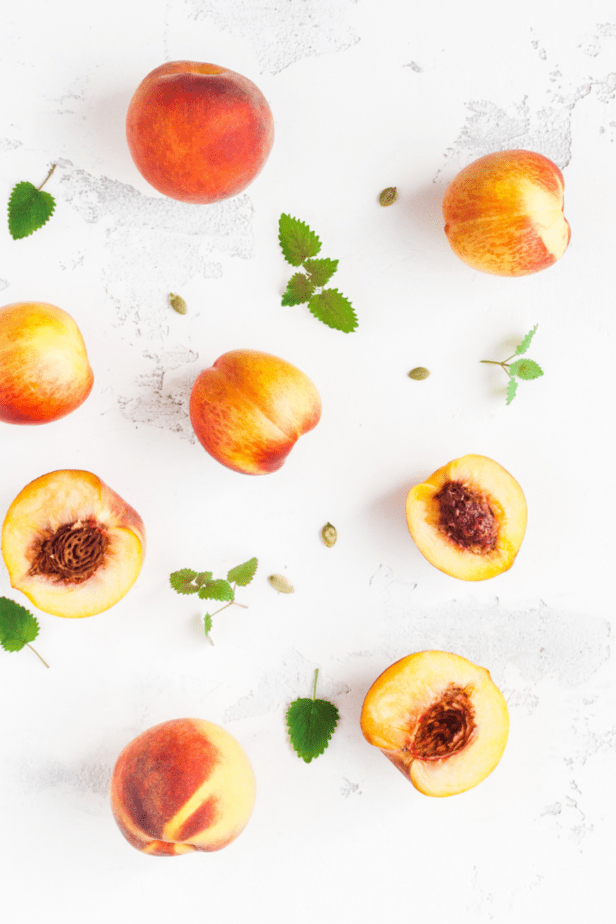 peaches scattered on a white counter