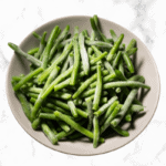 Green Beans in a white bowl on a marble counter